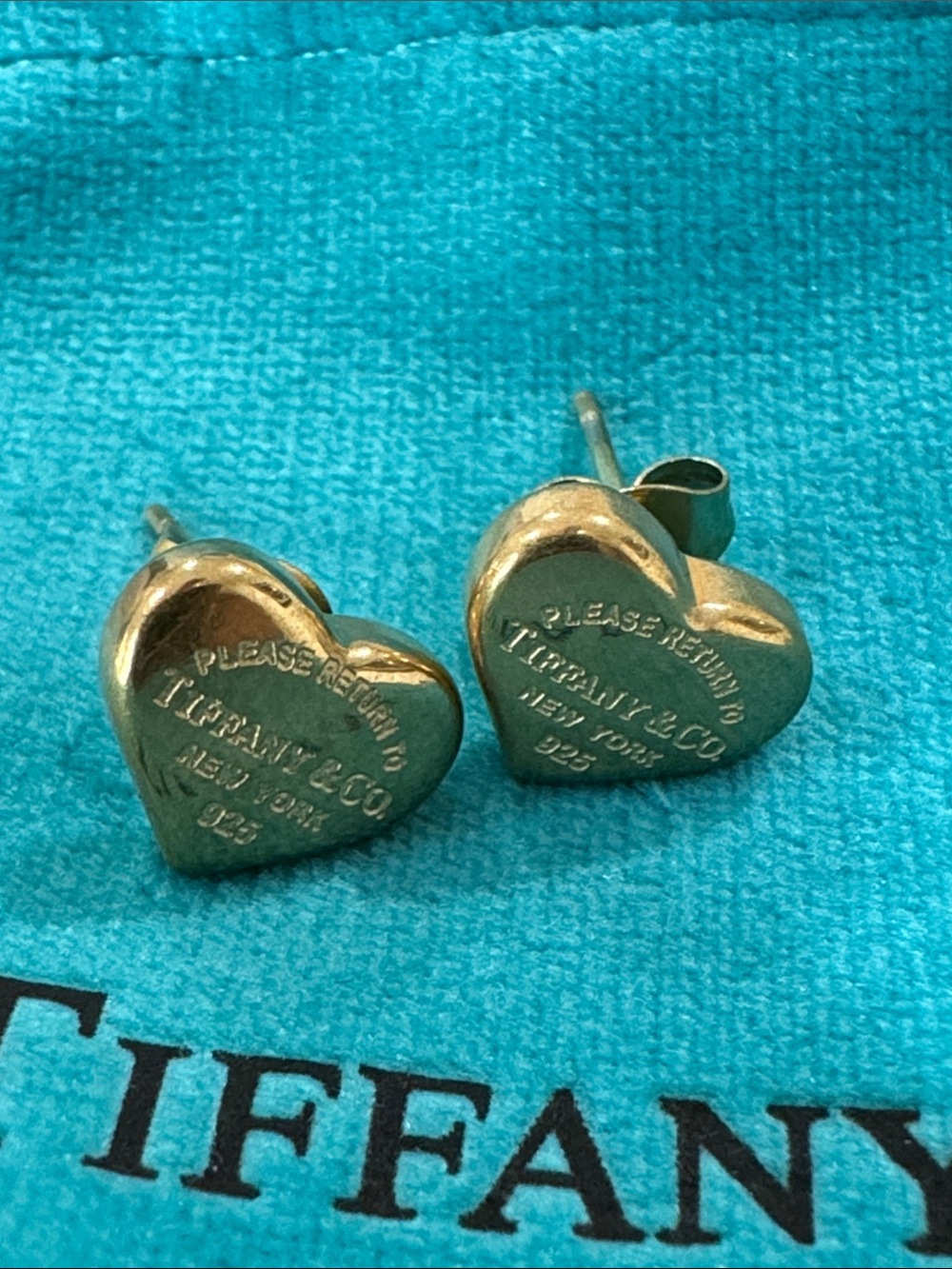 Gold Heart Stud Earrings on Blue Pouch